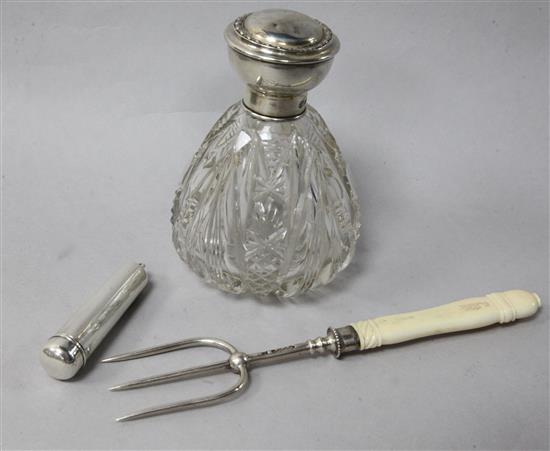 A George V silver mounted glass scent bottle, a silver fork and a silver cased amber cigarette holder.